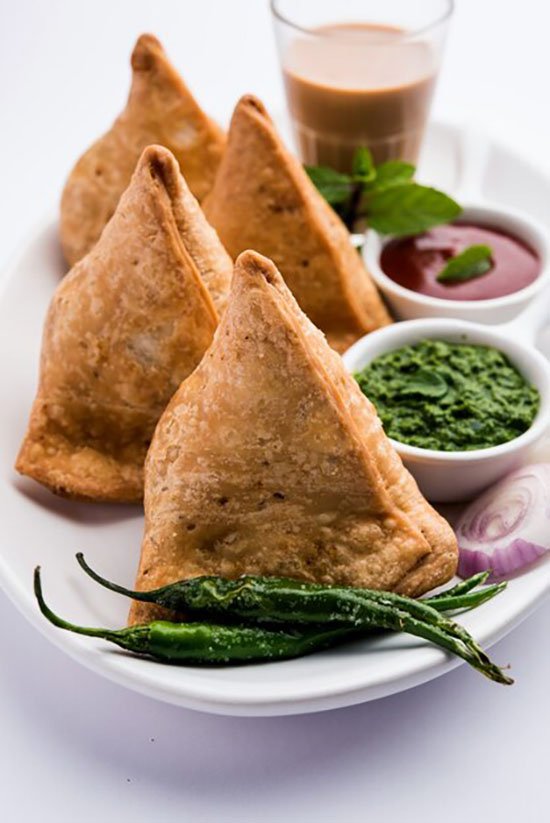 samosa-triangle-shape-fried-baked-pastry-with-savoury-filling-popular-indian-tea-time-snacks-served-with-green-chutney-tomato-ketchup_466689-2530 (1)